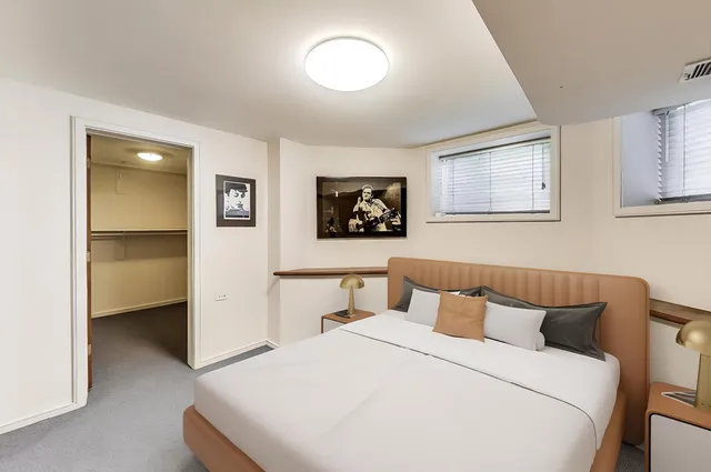 a bedroom with a bed and a painting