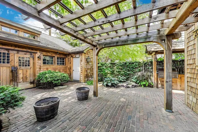 a view of a porch with furniture and garden