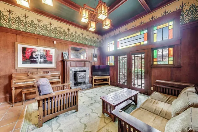 a living room with furniture a fireplace and a chandelier