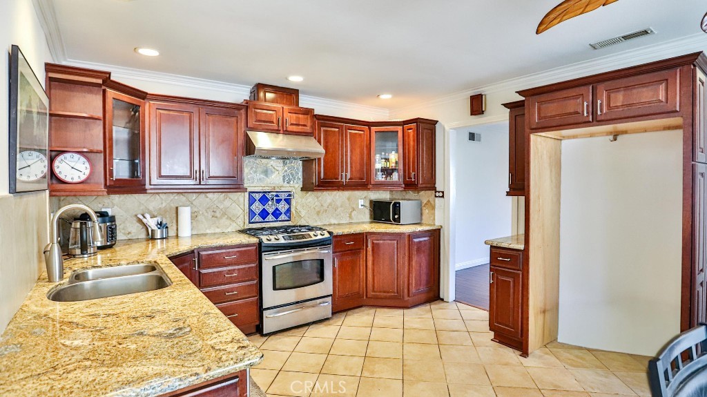 4862 Gainsport Circle Irvine, CA 92604 - Photo 11 of 24 a kitchen with stainless steel appliances granite countertop a refrigerator stove and sink