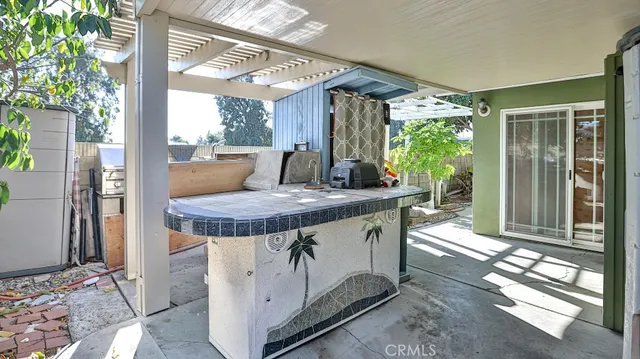 a view of a patio with table and chairs