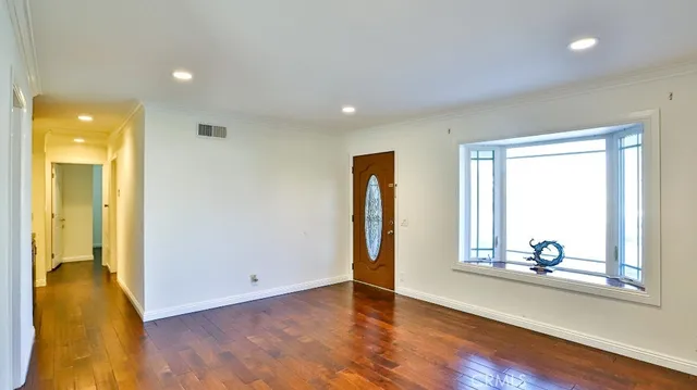 a view of room with window and wooden floor