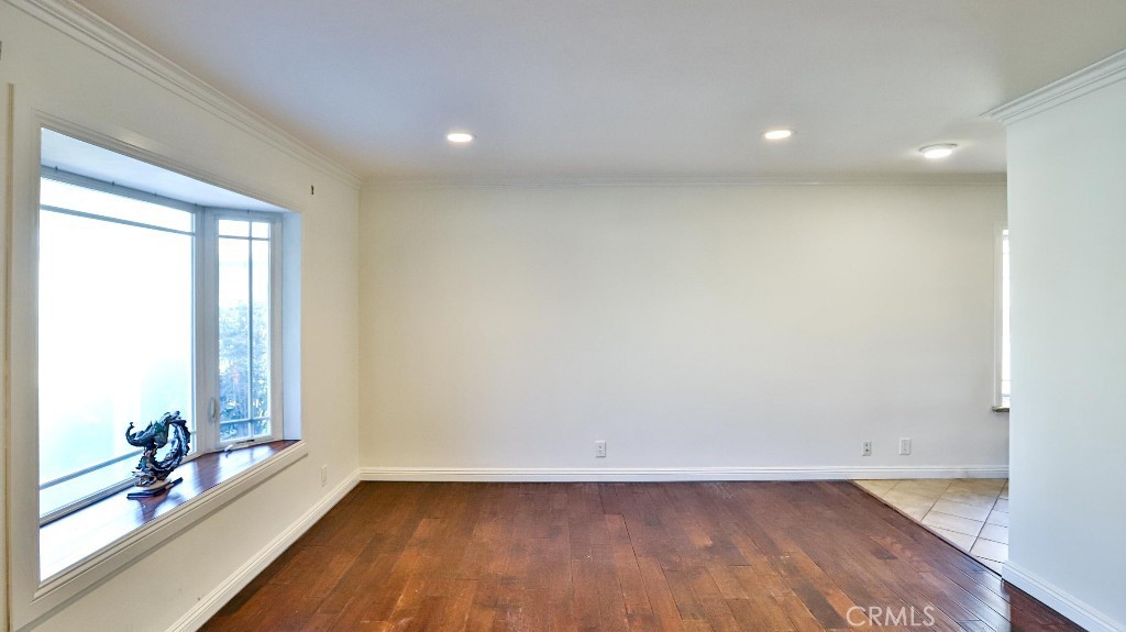 4862 Gainsport Circle Irvine, CA 92604 - Photo 6 of 24 an empty room with wooden floor and windows