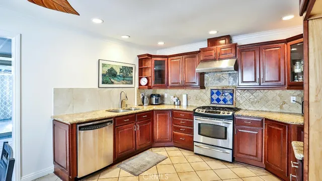 a kitchen with a stove sink and cabinets