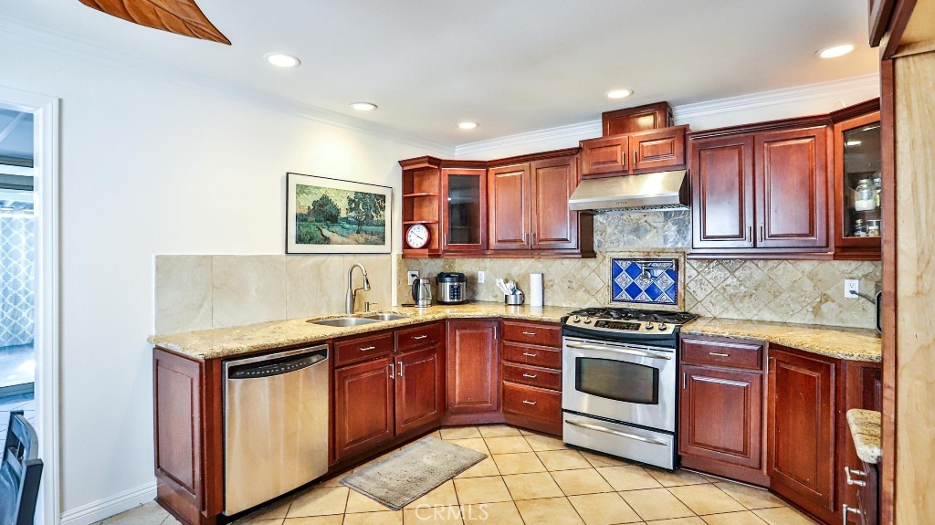 4862 Gainsport Circle Irvine, CA 92604 - Photo 7 of 24 a kitchen with a stove sink and cabinets
