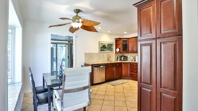 a kitchen with granite countertop wooden cabinets and stainless steel appliances