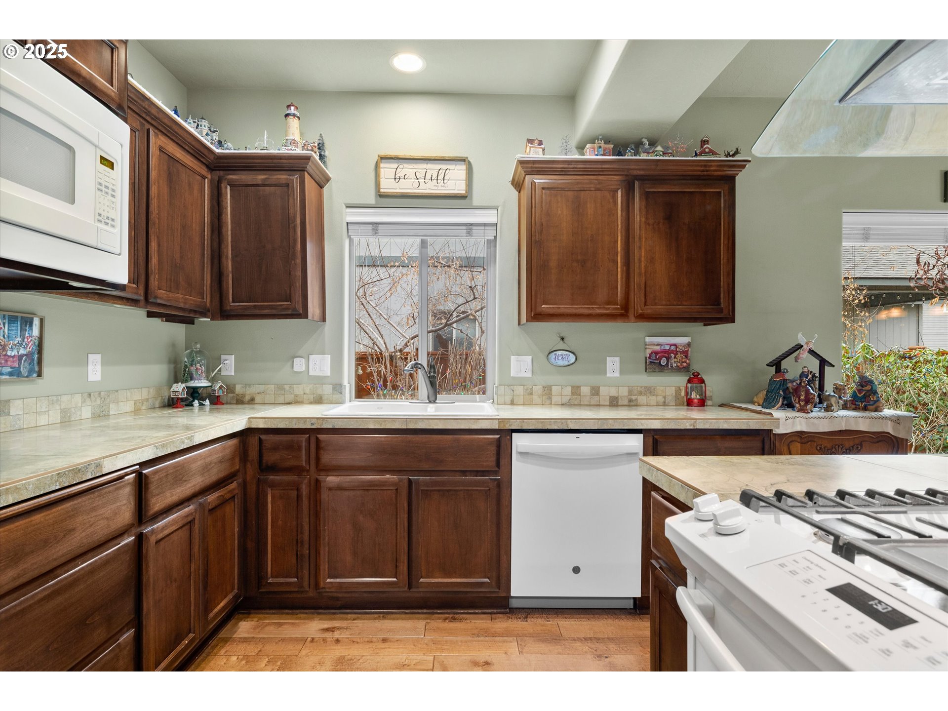 21281 Bellflower Place Bend, OR 97702 - Photo 11 of 48 a kitchen with a sink stove and cabinets