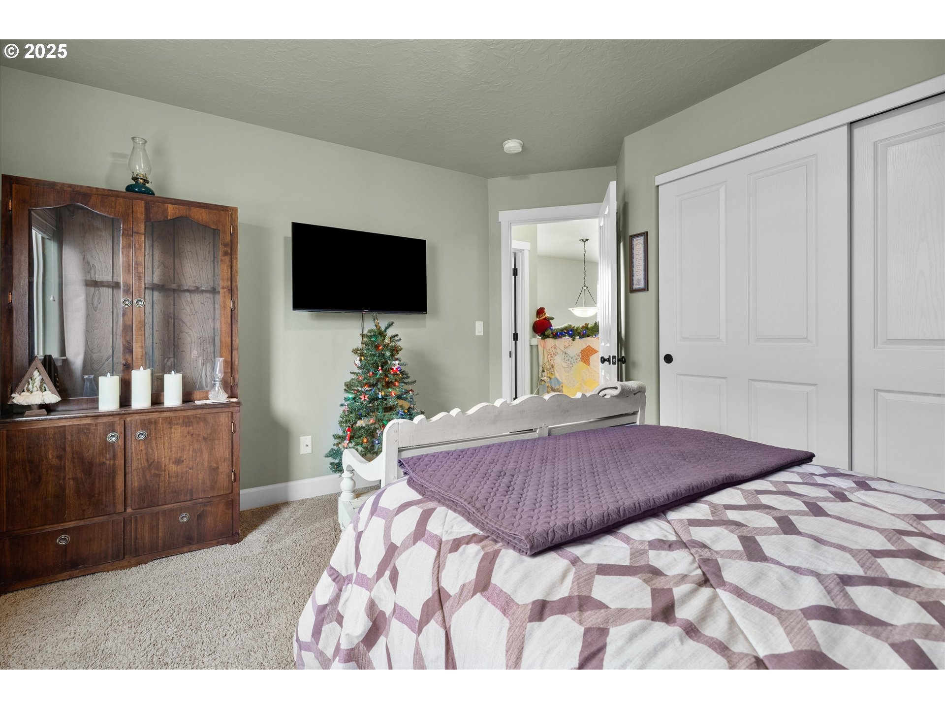 21281 Bellflower Place Bend, OR 97702 - Photo 27 of 48 a bedroom with a bed and a flat screen tv