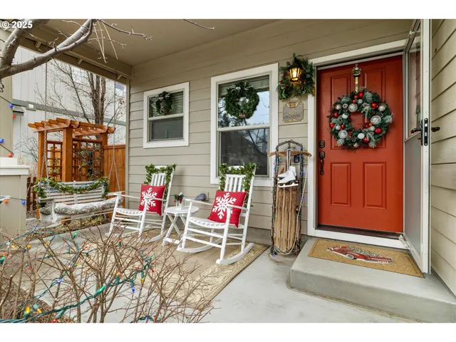 a living room with furniture a rug and flowers
