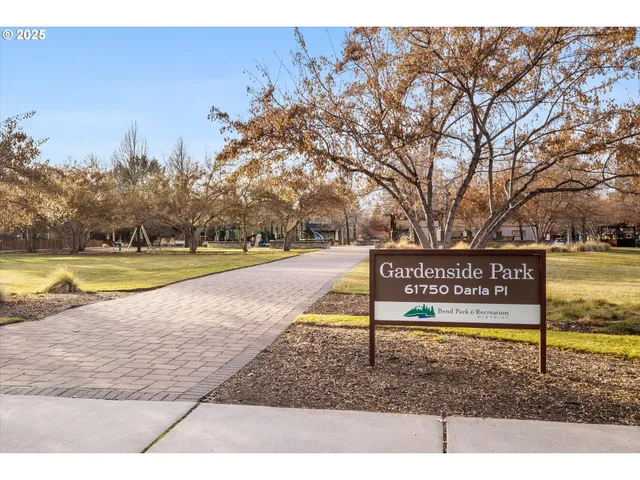 a view of swimming pool with outdoor seating and trees in the background