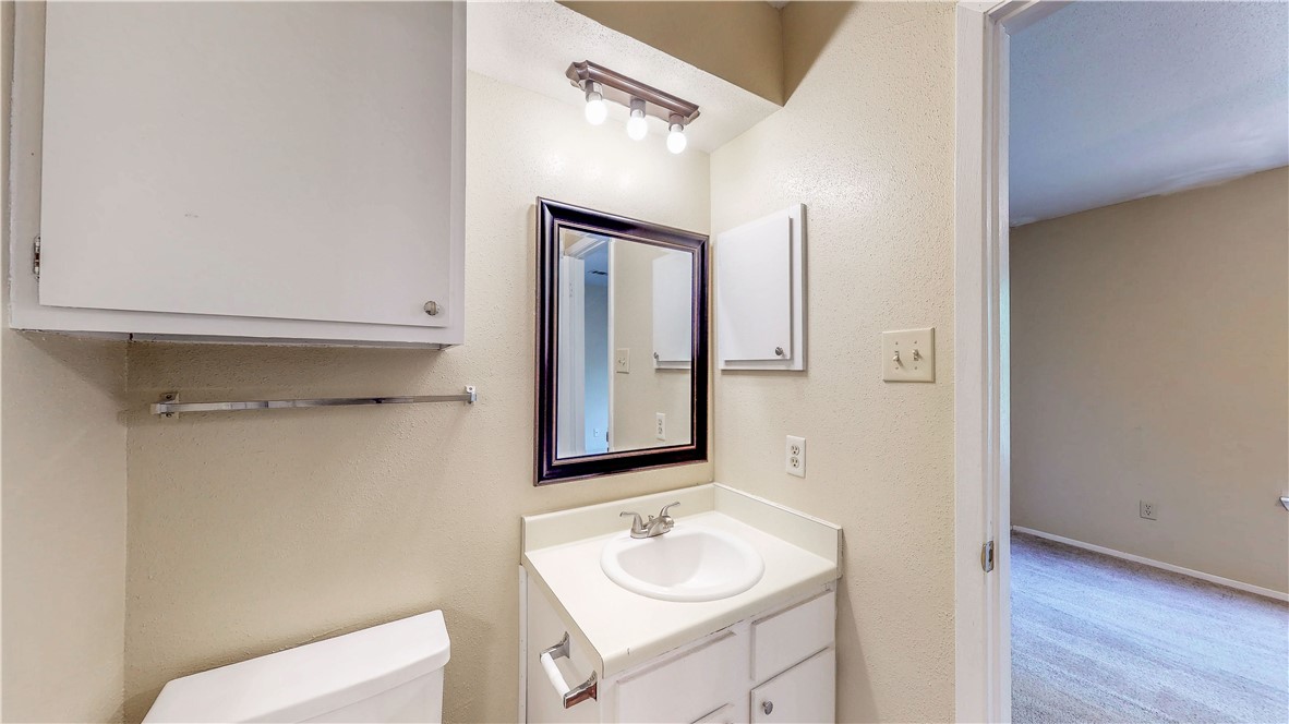 301 Manuel Drive, Unit C College Station, TX 77840 - Photo 14 of 25 a bathroom with a sink and a mirror