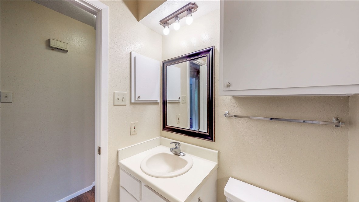 301 Manuel Drive, Unit C College Station, TX 77840 - Photo 19 of 25 a bathroom with a sink and a mirror