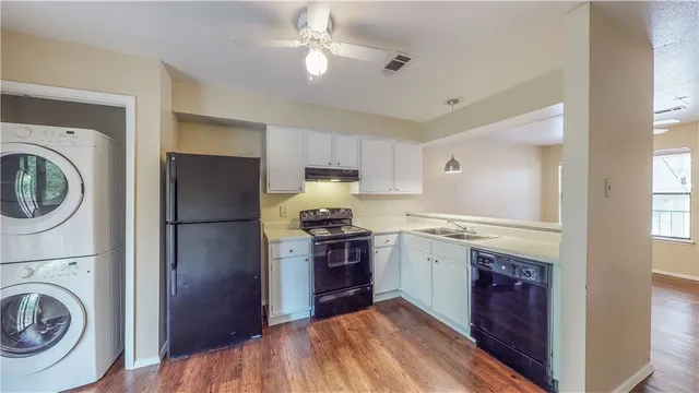 a kitchen with a stove top oven and refrigerator