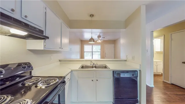 a kitchen with a sink stove and cabinets