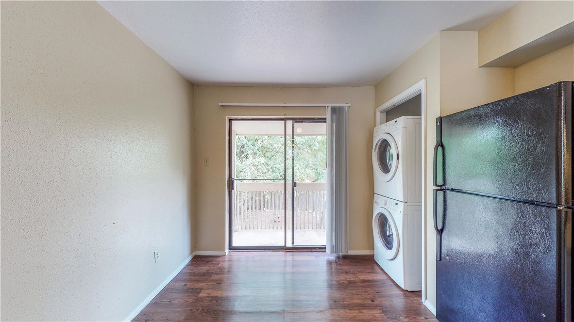 301 Manuel Drive, Unit C College Station, TX 77840 - Photo 7 of 25 a view of a refrigerator in kitchen and wooden floor
