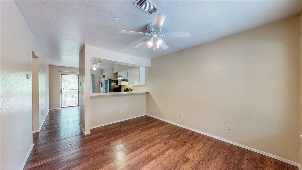 301 Manuel Drive, Unit C College Station, TX 77840 - Photo 10 of 25 a view of a kitchen with wooden floor and a kitchen