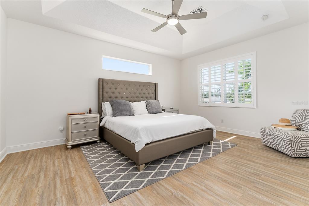 4987 Southwest 63rd Loop Ocala, FL 34474 - Photo 28 of 56 a bedroom with a bed and wooden floor