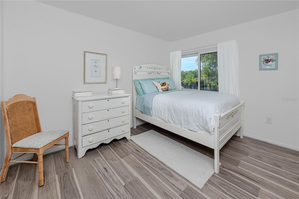 2207 Belleair Road, Unit B30 Clearwater, FL 33764 - Photo 23 of 39 a bed room with a bed and a chair