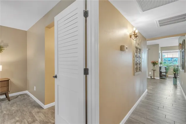 a spacious bedroom with a bed and a chandelier