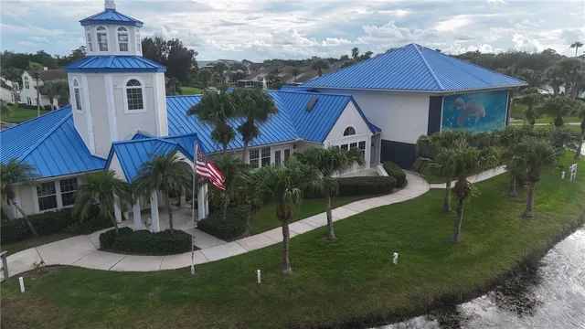 an aerial view of a house with a garden and lake view