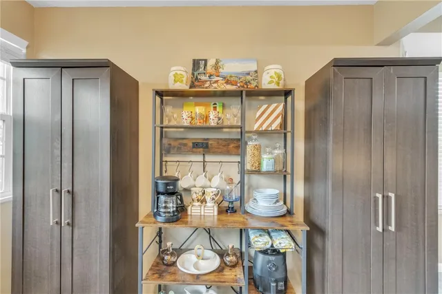 a kitchen with stainless steel appliances granite countertop a refrigerator a stove a sink and a window