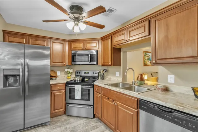 a kitchen with stainless steel appliances granite countertop a stove a refrigerator and a microwave
