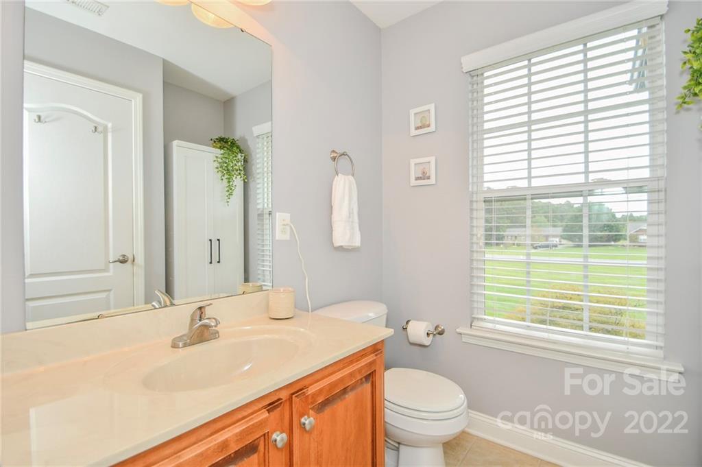 2904 Ruben Road Monroe, NC 28112 - Photo 8 of 26 a bathroom with a sink a toilet and a window