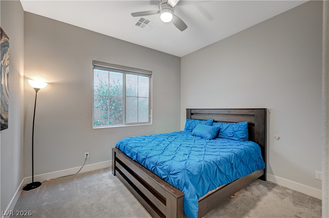 3943 Reyes Avenue Las Vegas, NV 89141 - Photo 26 of 95 A tranquil sleeping space featuring a window with natural light and a comforting ceiling fan.