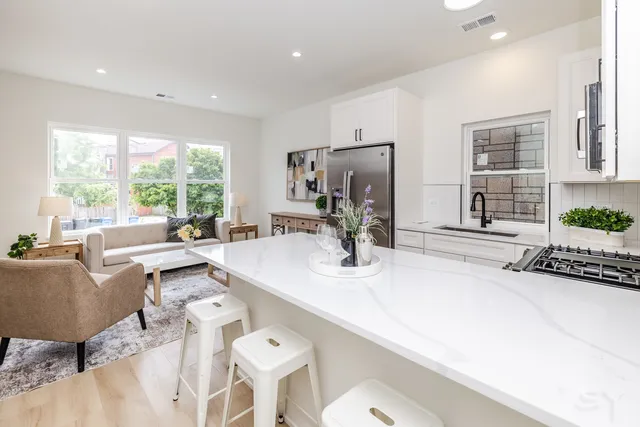 a living room with furniture a large window and a table