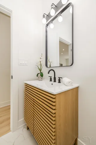 a bathroom with a sink and a mirror