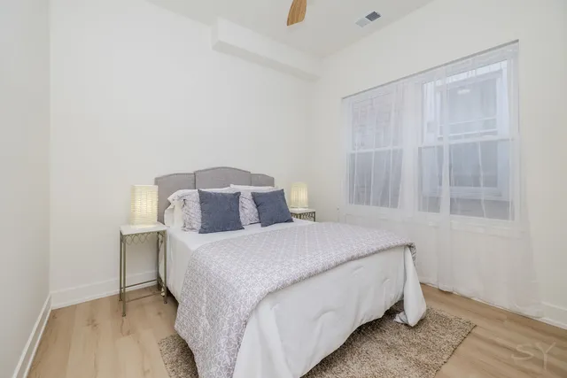 a bedroom with a bed and a chandelier