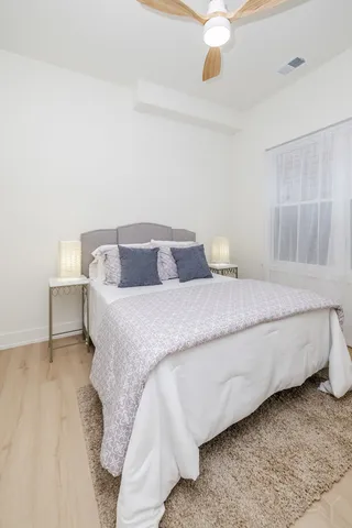 a bedroom with a bed and a window