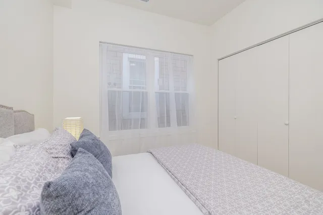 a bedroom with a bed and a shower