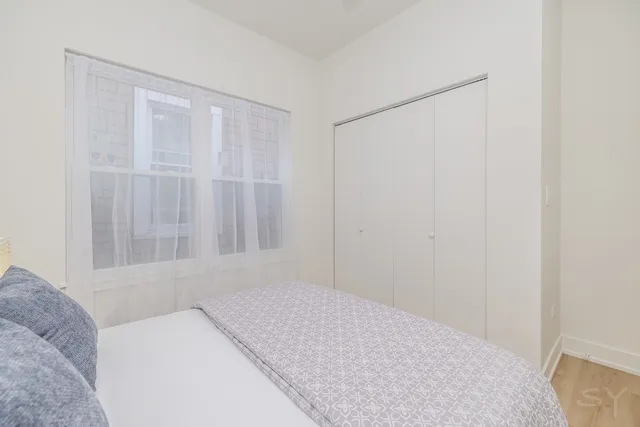 a bedroom with a bed and a night stand