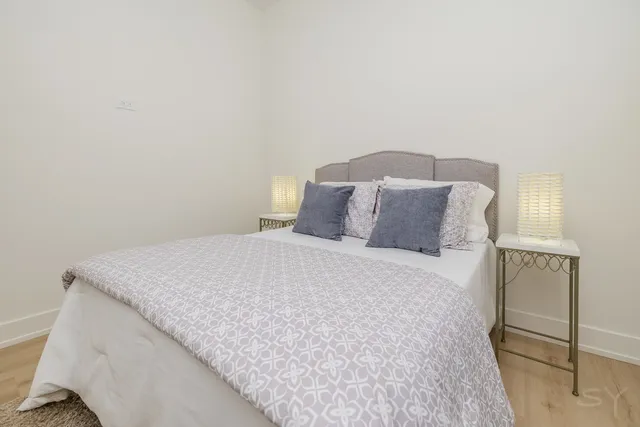 a large bed sitting in a bedroom next to a wooden cabinet