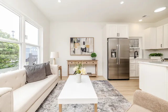 a living room with a couch and a refrigerator