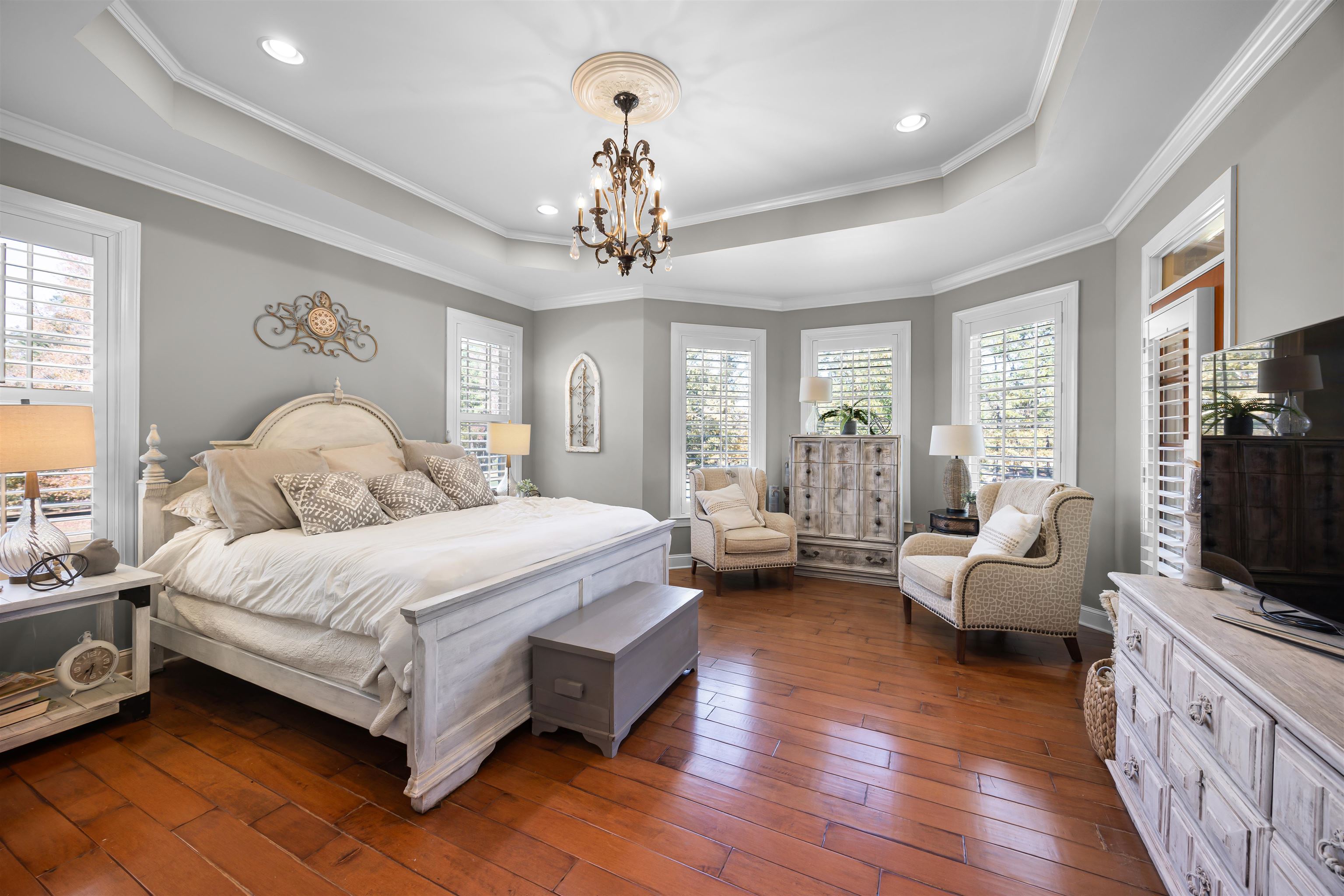 140 Legends Drive Counce, TN 38326 - Photo 16 of 30 Bedroom with a raised ceiling, dark wood finished floors, ornamental molding, recessed lighting, and a chandelier