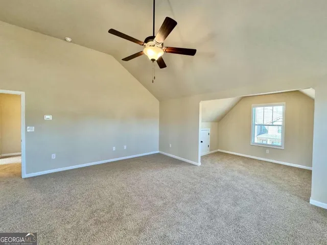 a view of a livingroom with a chandelier fan