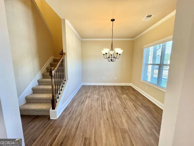 a view of entryway and hall with wooden floor