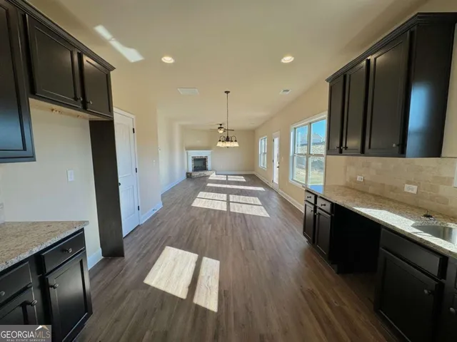 wooden floor in an empty room with a fireplace
