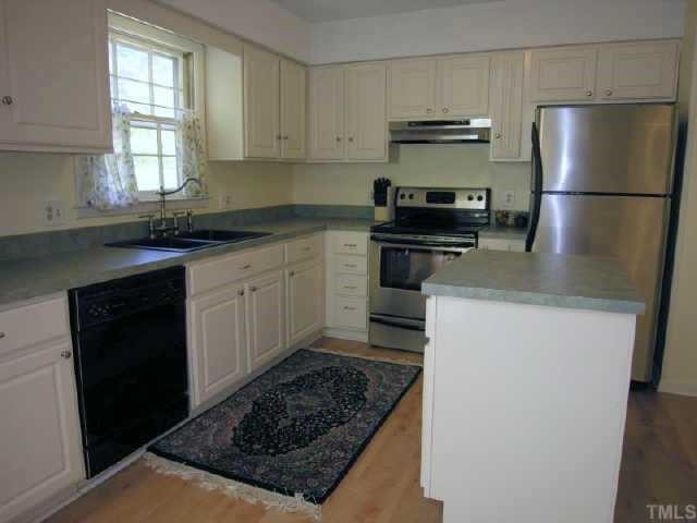 8900 Brandon Station Road Raleigh, NC 27613 - Photo 5 of 10 Appliances include Stainless Steel Range and Refrigerator, Built-in Dishwasher, and Portable Island in the Kitchen Other