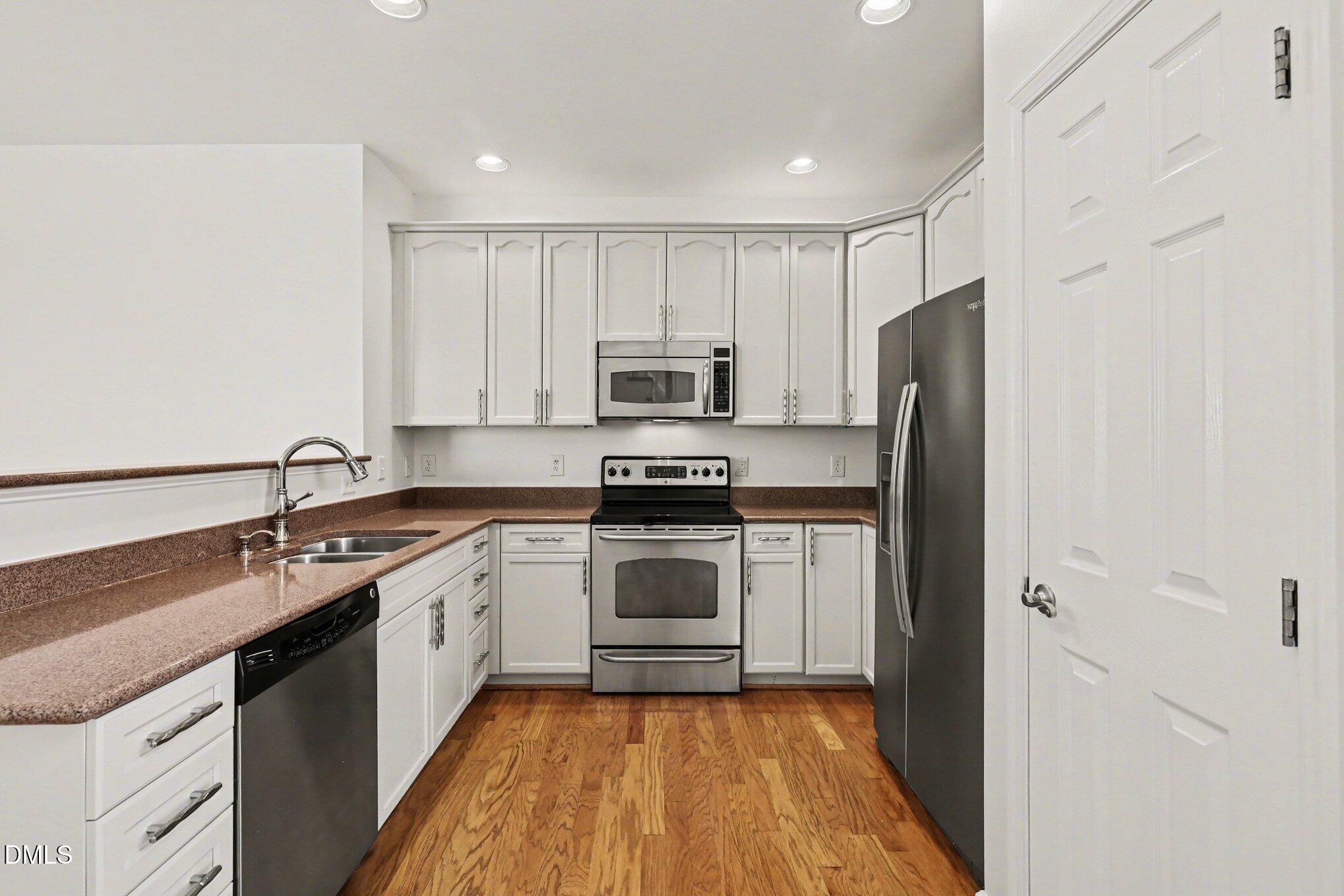 723 Swan Neck Lane Raleigh, NC 27615 - Photo 10 of 52 a kitchen with a sink stove and refrigerator