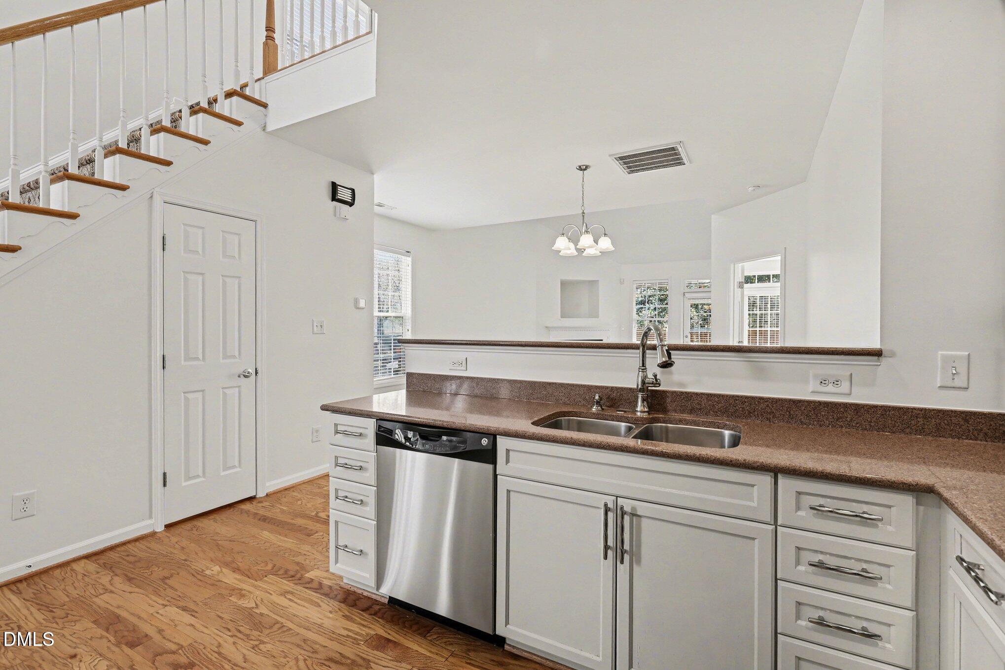 723 Swan Neck Lane Raleigh, NC 27615 - Photo 12 of 52 a kitchen with stainless steel appliances granite countertop a sink a stove and a wooden floors