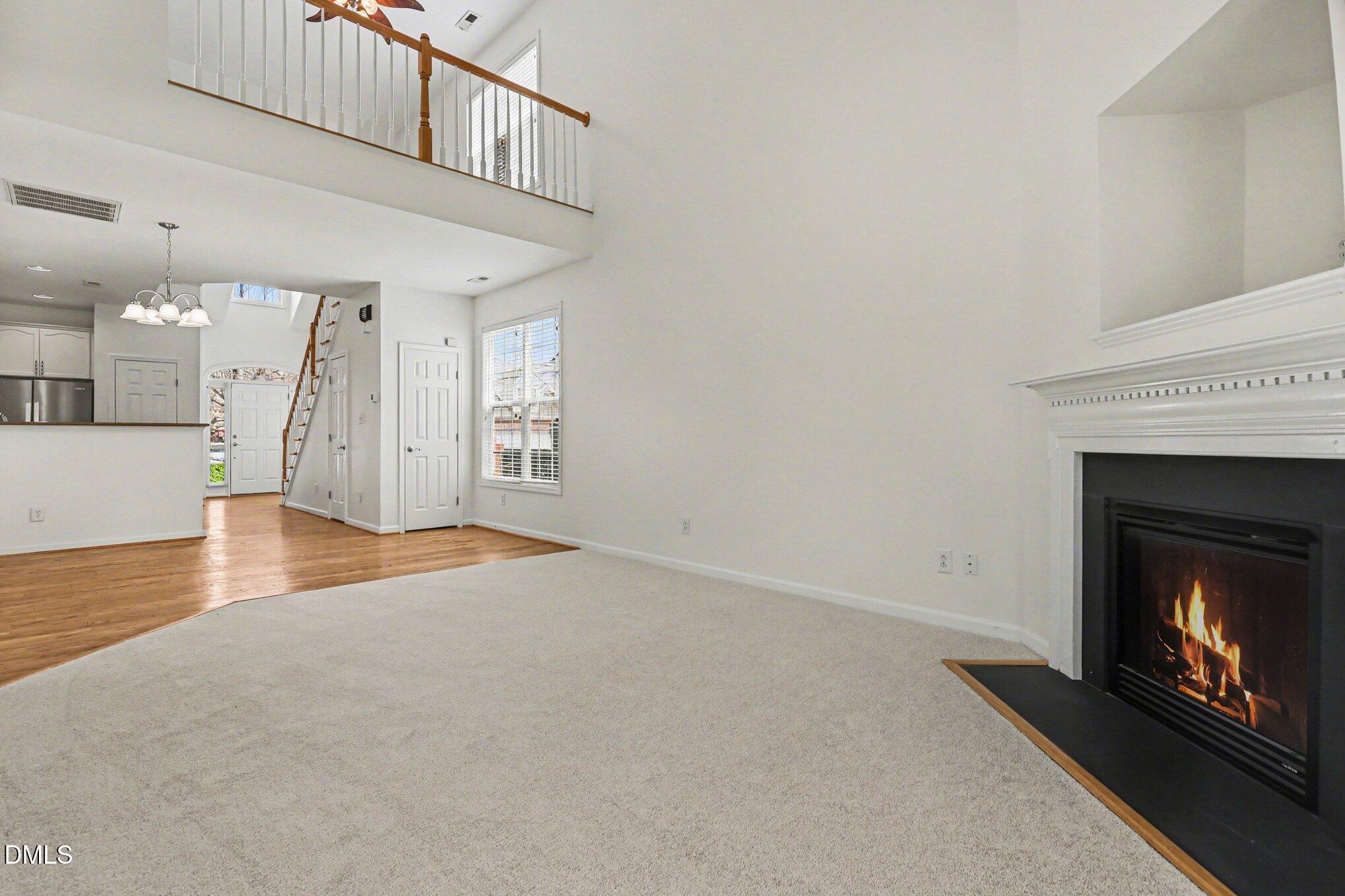 723 Swan Neck Lane Raleigh, NC 27615 - Photo 15 of 52 a view of an empty room with wooden floor fireplace and a window
