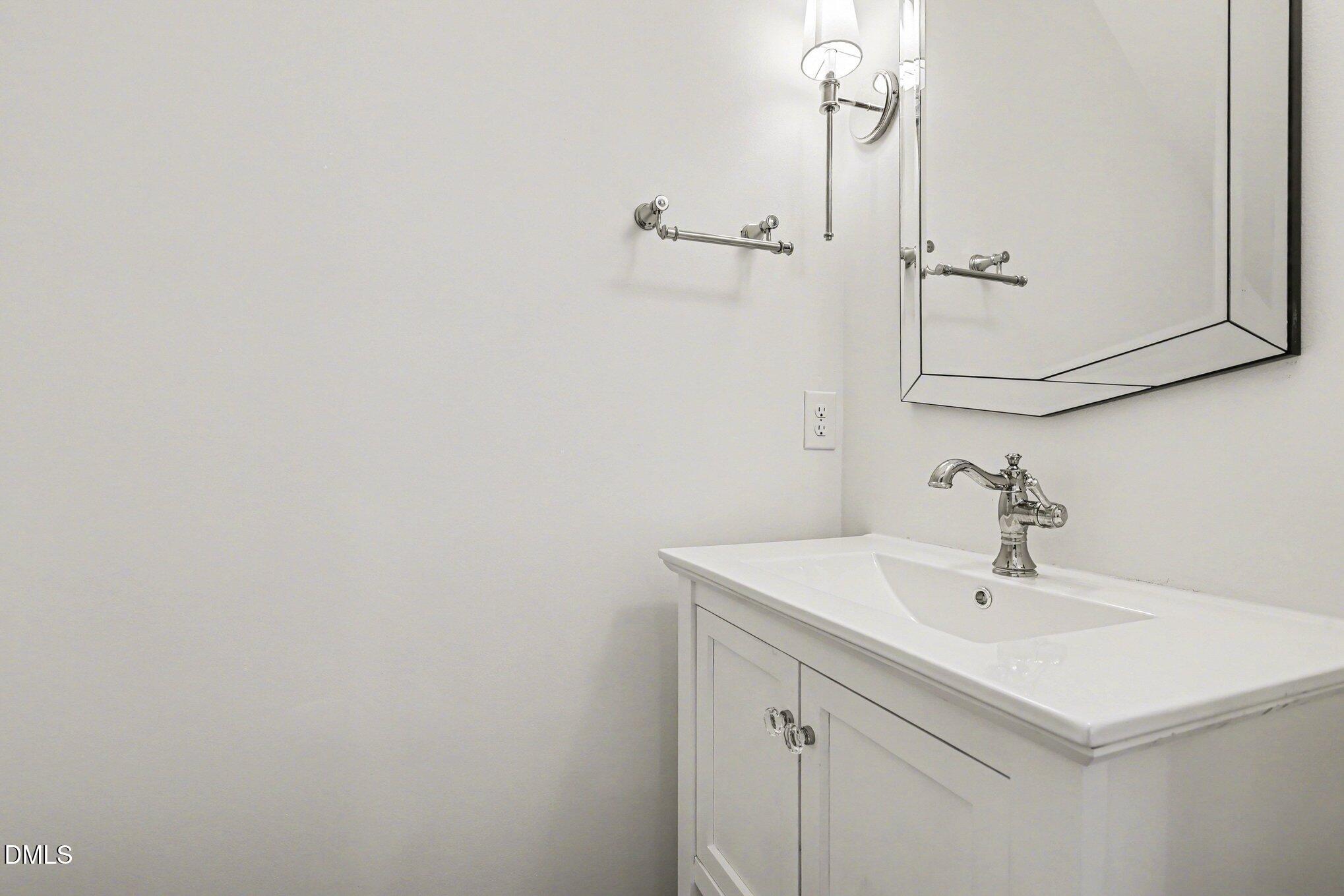 723 Swan Neck Lane Raleigh, NC 27615 - Photo 17 of 52 a bathroom with a sink a mirror and vanity