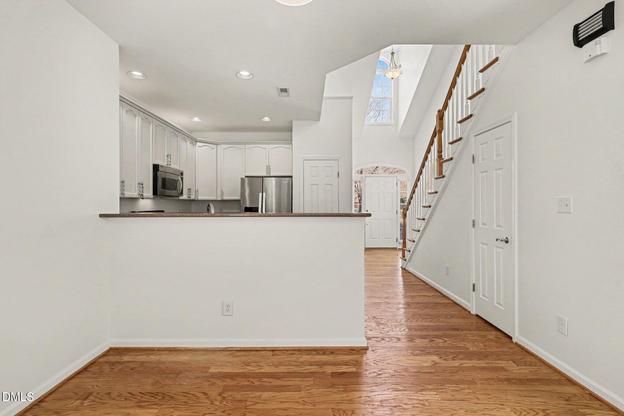 723 Swan Neck Lane Raleigh, NC 27615 - Photo 18 of 52 a view of a kitchen with wooden floor and electronic appliances