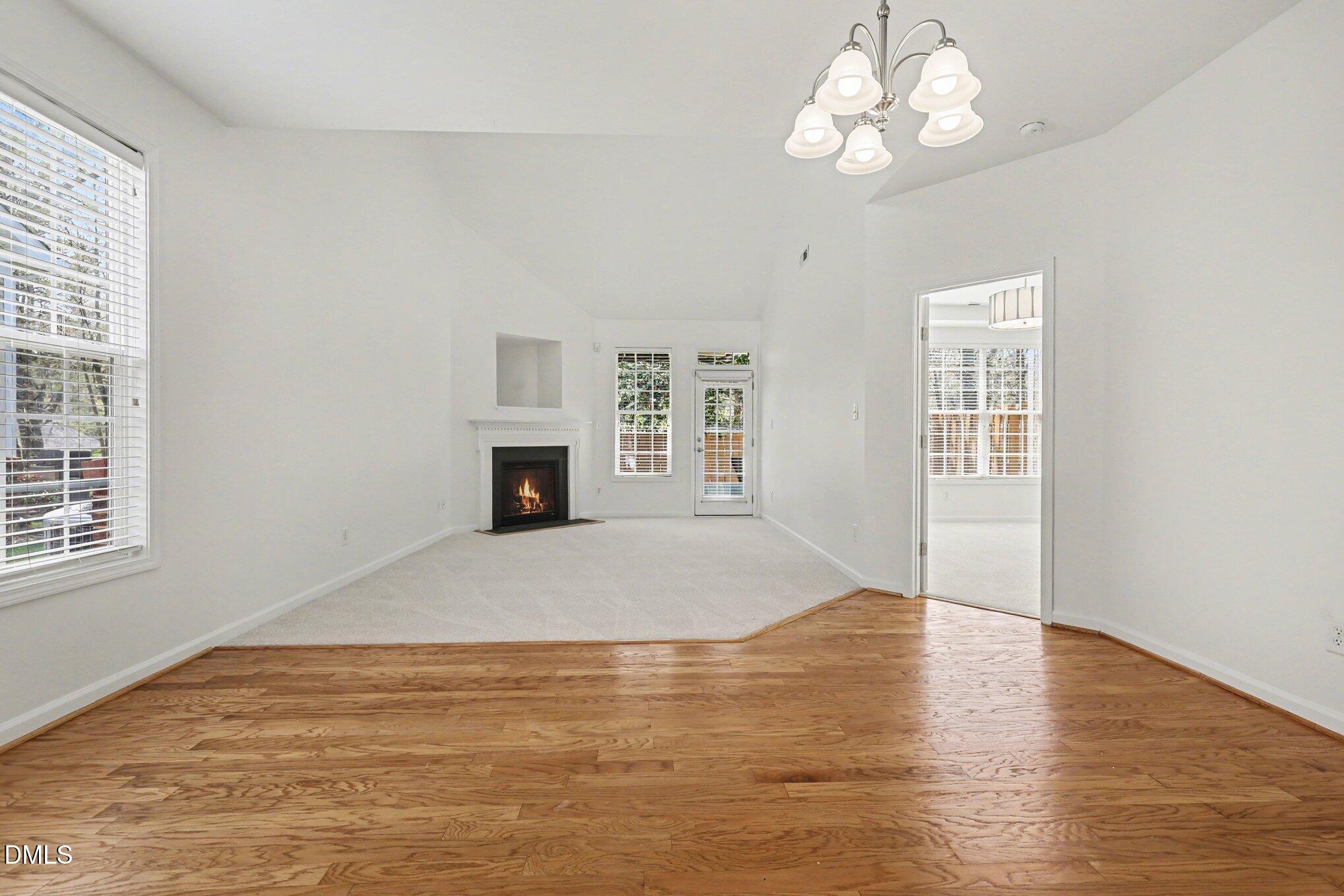723 Swan Neck Lane Raleigh, NC 27615 - Photo 19 of 52 a view of an empty room with wooden floor and a window