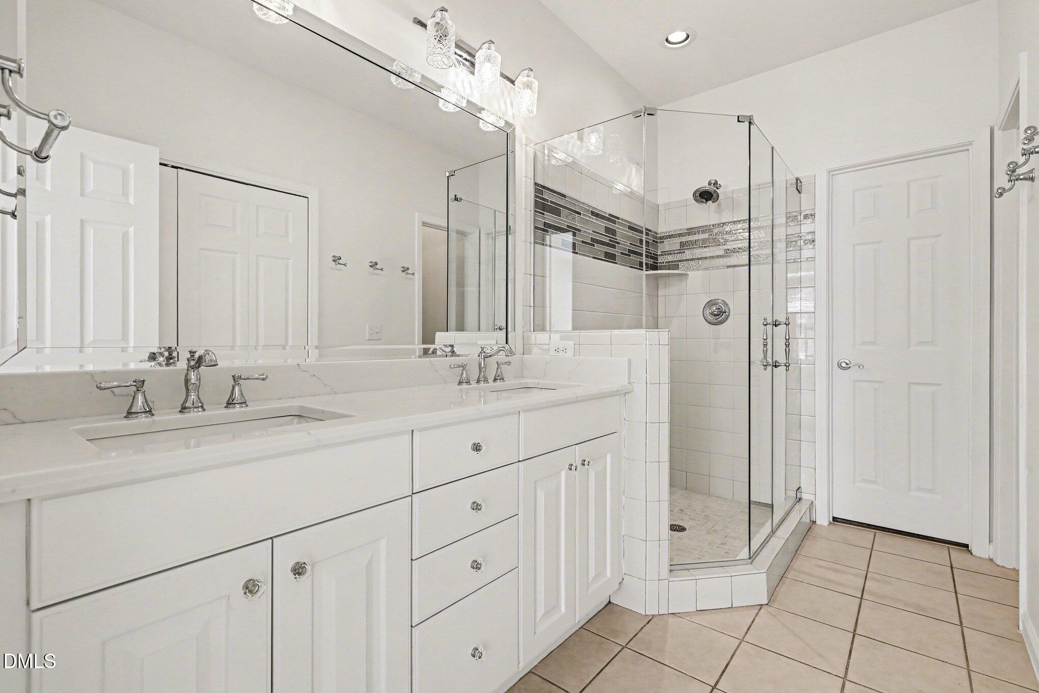 723 Swan Neck Lane Raleigh, NC 27615 - Photo 23 of 52 a bathroom with a granite countertop sink mirror and double