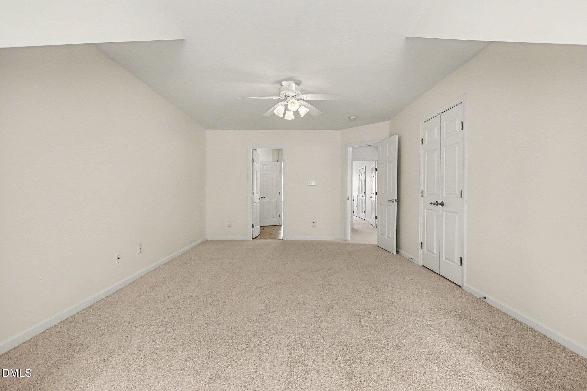 723 Swan Neck Lane Raleigh, NC 27615 - Photo 26 of 52 an empty room with an entryway and chandelier fan