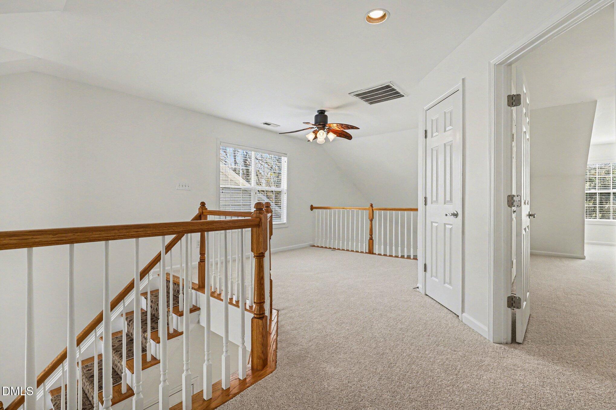 723 Swan Neck Lane Raleigh, NC 27615 - Photo 27 of 52 a view of a hallway with wooden floor and staircase